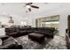 Bright and open living area with leather sectional sofa and a view to backyard at 2052 E Scorpio Pl, Chandler, AZ 85249