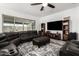 Open living space with a leather sofa, media center, ceiling fan and natural light at 2052 E Scorpio Pl, Chandler, AZ 85249