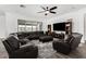 Open living room with large sectional, media center, ceiling fan and natural light at 2052 E Scorpio Pl, Chandler, AZ 85249