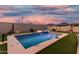 Backyard pool with basketball hoop, putting green, cabana, and beautiful pink sunset sky at 2052 E Scorpio Pl, Chandler, AZ 85249