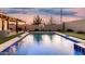 Backyard pool with covered patio, basketball hoop, putting green and turf at 2052 E Scorpio Pl, Chandler, AZ 85249
