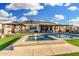 Backyard pool and spa with cabana, umbrella, and putting green on a sunny day at 2052 E Scorpio Pl, Chandler, AZ 85249
