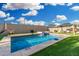 Backyard pool with basketball hoop, putting green, cabana, umbrella, and turf at 2052 E Scorpio Pl, Chandler, AZ 85249