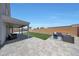 Home's backyard featuring modern patio furniture and lush artificial turf at 21754 W Pima St, Buckeye, AZ 85326