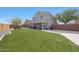 Home exterior showcasing artificial turf, block fence, and stucco siding at 21754 W Pima St, Buckeye, AZ 85326