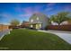 Beautiful home backyard with artificial grass, neutral stucco and block fence at 21754 W Pima St, Buckeye, AZ 85326