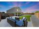 Backyard view with artificial turf, block fence and modern patio furniture at 21754 W Pima St, Buckeye, AZ 85326