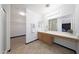 Bright and spacious bathroom with a large countertop and dual mirrors and access to walk in closet at 21754 W Pima St, Buckeye, AZ 85326