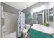 Updated bathroom featuring a shower with grab bar and stylish blue vanity and floating shelves at 21754 W Pima St, Buckeye, AZ 85326