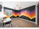 Bedroom featuring a colorful accent wall, neutral walls, a ceiling fan, and a desk at 21754 W Pima St, Buckeye, AZ 85326