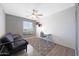 Cozy bedroom features neutral walls, ceiling fan, futon, desk and geometric rug at 21754 W Pima St, Buckeye, AZ 85326