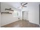 Bright bedroom with a ceiling fan, wood-look floors, and closet with shelving unit ready for organization at 21754 W Pima St, Buckeye, AZ 85326