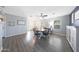 Bright dining area featuring wood-look floors, a round table, and a view of the front yard at 21754 W Pima St, Buckeye, AZ 85326