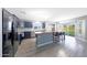 Modern kitchen with stainless steel appliances, granite countertops, and a large island at 21754 W Pima St, Buckeye, AZ 85326