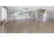 Open-concept living room with built-in cabinets, wood-look floors, and a cozy atmosphere at 21754 W Pima St, Buckeye, AZ 85326