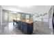 Spacious living room with a kitchen island, offering seating and a seamless flow to the backyard at 21754 W Pima St, Buckeye, AZ 85326