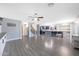 Large open-concept living space with a kitchen island, wood-look floors, and staircase at 21754 W Pima St, Buckeye, AZ 85326
