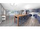 Open concept living area with kitchen island, wood-look floors, and built-in cabinets at 21754 W Pima St, Buckeye, AZ 85326