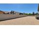 Spacious backyard with gravel and RV parking behind the block wall, under a clear blue sky at 21985 E Quintero Rd, Queen Creek, AZ 85142