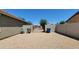 Large backyard with gravel and gated entry; perfect for parking cars, RVs, and more at 21985 E Quintero Rd, Queen Creek, AZ 85142