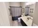 A well lit bathroom features a tub/shower combo and vanity with dark cabinets at 21985 E Quintero Rd, Queen Creek, AZ 85142