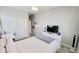 Stylish bedroom featuring a bed, large windows, a sliding closet, and a modern dresser with a television at 21985 E Quintero Rd, Queen Creek, AZ 85142