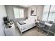 Bright bedroom showcasing a bed, stylish decor, tiled floors, and large windows offering plenty of natural light at 21985 E Quintero Rd, Queen Creek, AZ 85142