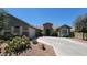 Beautiful home with desert landscaping, stone accents, and a long driveway at 21985 E Quintero Rd, Queen Creek, AZ 85142