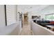 Hallway leading to a spacious living room with an open floor plan and modern decor at 21985 E Quintero Rd, Queen Creek, AZ 85142
