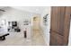 Hallway leading to living room with open archway and dark wood door at 21985 E Quintero Rd, Queen Creek, AZ 85142