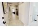 An inviting hallway with tile flooring, closet, and laundry access at 21985 E Quintero Rd, Queen Creek, AZ 85142