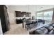 Open concept kitchen with large island, stainless appliances, dark cabinetry and tile flooring at 21985 E Quintero Rd, Queen Creek, AZ 85142