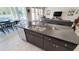 Kitchen island with sink and dishwasher, stainless steel appliances and dark cabinets and countertops at 21985 E Quintero Rd, Queen Creek, AZ 85142
