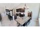 Spacious kitchen with granite counters, stainless appliances, island, dining table and dark cabinets at 21985 E Quintero Rd, Queen Creek, AZ 85142