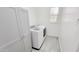 Bright laundry room features a new washer and dryer next to white storage cabinets at 21985 E Quintero Rd, Queen Creek, AZ 85142