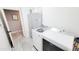 Well-lit laundry room with a side-by-side washer and dryer and storage cabinets at 21985 E Quintero Rd, Queen Creek, AZ 85142