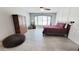 Spacious bedroom with tile floors, large window, and a comfortable seating area at 21985 E Quintero Rd, Queen Creek, AZ 85142