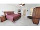 Bedroom with tiled floors, large windows, ceiling fan and comfortable furnishings at 21985 E Quintero Rd, Queen Creek, AZ 85142