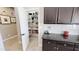 Walk-in pantry is equipped with built in shelving and stocked with food and household items at 21985 E Quintero Rd, Queen Creek, AZ 85142