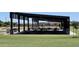 Covered picnic area with multiple tables and benches offering a shaded outdoor gathering space at 21985 E Quintero Rd, Queen Creek, AZ 85142
