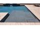 The in-ground pool has a shallow area with integrated drains, making it a perfect place to unwind at 21985 E Quintero Rd, Queen Creek, AZ 85142