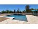 Beautiful pool area with a shimmering waterfall, ample lounging space, and inviting water features at 21985 E Quintero Rd, Queen Creek, AZ 85142