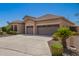 Well-maintained home with a spacious driveway, three-car garage, and desert landscaping at 22304 N 104Th Ln, Peoria, AZ 85383