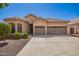 Charming single-story home featuring a tile roof, two-car garage, and low-maintenance desert landscaping at 22304 N 104Th Ln, Peoria, AZ 85383