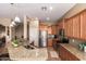 Kitchen featuring stainless steel appliances, granite countertops, and wooden cabinets at 22304 N 104Th Ln, Peoria, AZ 85383