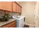 Functional laundry room with upper cabinets and modern washer and dryer units for added convenience at 22304 N 104Th Ln, Peoria, AZ 85383