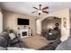 Open living room with a fireplace, TV, and comfortable seating area at 22304 N 104Th Ln, Peoria, AZ 85383