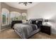 Stylish main bedroom featuring a decorative window, neutral tones, and nightstands at 22304 N 104Th Ln, Peoria, AZ 85383