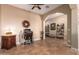 Home office featuring a built-in desk, shelving, and ample natural light at 22304 N 104Th Ln, Peoria, AZ 85383