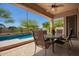 Inviting covered patio with a ceiling fan and a view of the sparkling pool, perfect for outdoor relaxation at 22304 N 104Th Ln, Peoria, AZ 85383